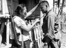 Captain Nieves Fernandez, with a brand new .30 cal. M1 Carbine and a sharp bolo, shows US Army Pvt. Andrew Lupiba how she used her long knife to silently kill Japanese soldiers during the Japanese occupation of Leyte Island. Image taken by Stanley Troutman on 7 November 1944, at Mabuhay Las Piñas, Leyte Island, Philippines.