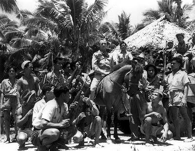 Capt. Locolvero on horseback, surrounded by guerrilla forces, Zamboanga, 1945